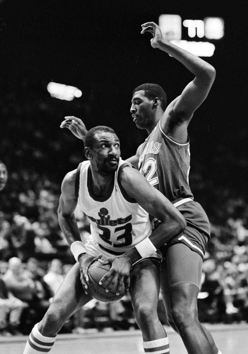 In this April 1, 1988, file photo, Washington Bullets' Charles Jones, left, drives for the...