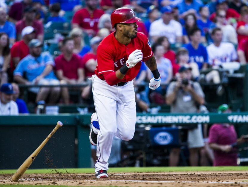 Texas Rangers center fielder Ian Desmond (20) runs to first base during the third inning of...