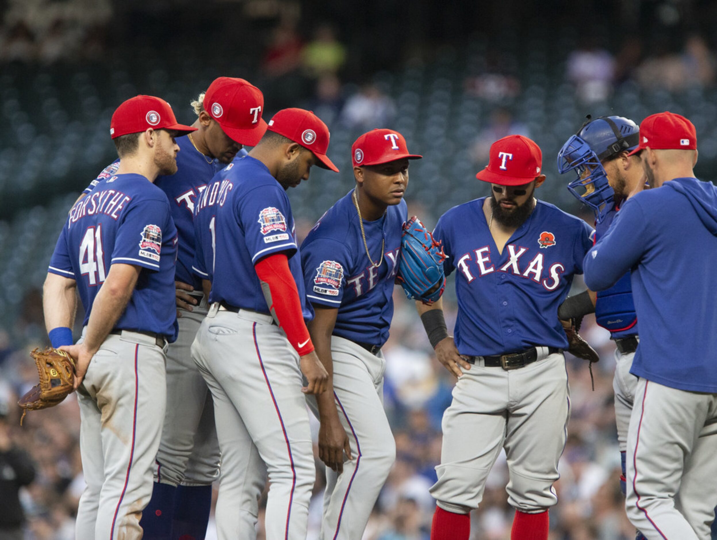 SEATTLE, WA - MAY 27:  Jose Leclerc #25 of the Texas Rangers, center, grabs at his right leg...