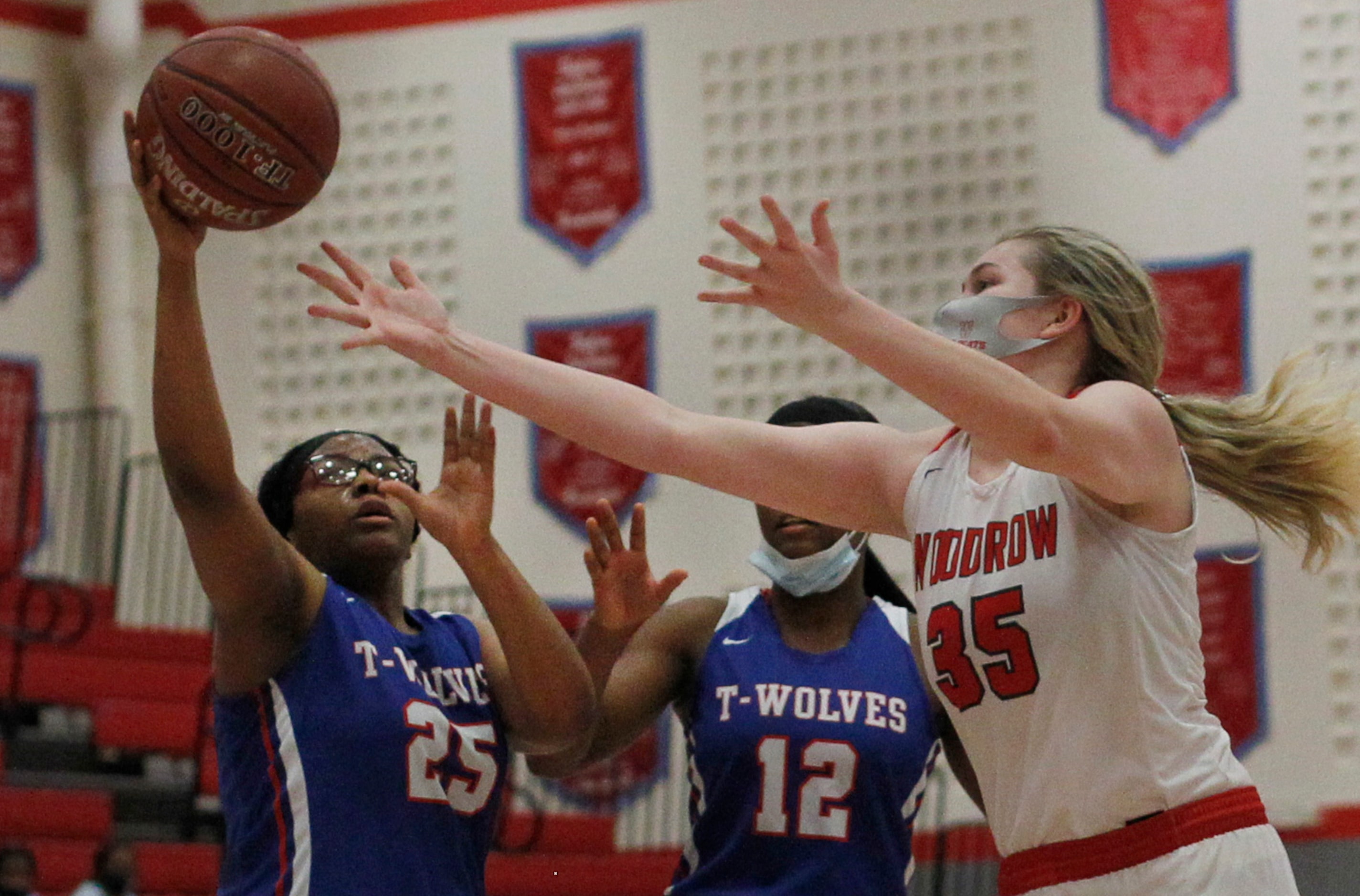 Dallas Woodrow Wilson's Allison King (35) reaches as she challenges Dallas Spruce post Tiara...