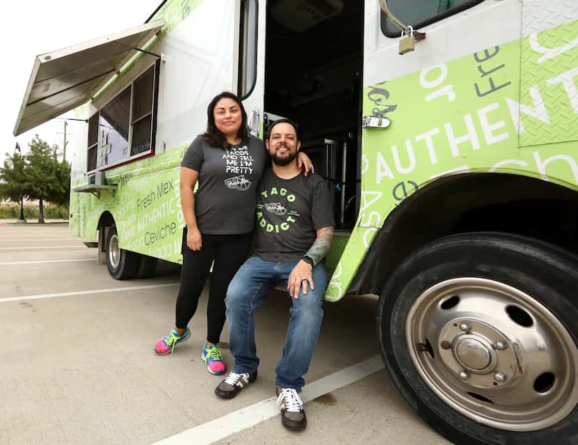 Jessica Thibodeaux, left, and Mark Thibodeaux pose for a photograph with their Fresh Mex...