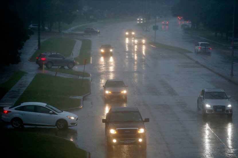 Commuters navigate Coit Road north of 15th Street in Plano in heavy rain in this file photo....