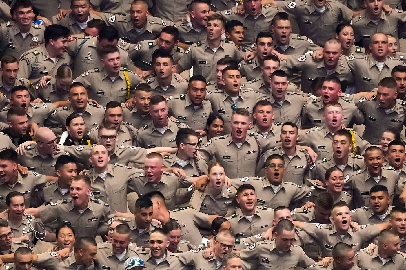 Members of the Texas A&M Corps of Cadets sing the Aggie War Hymn before an NCAA football...