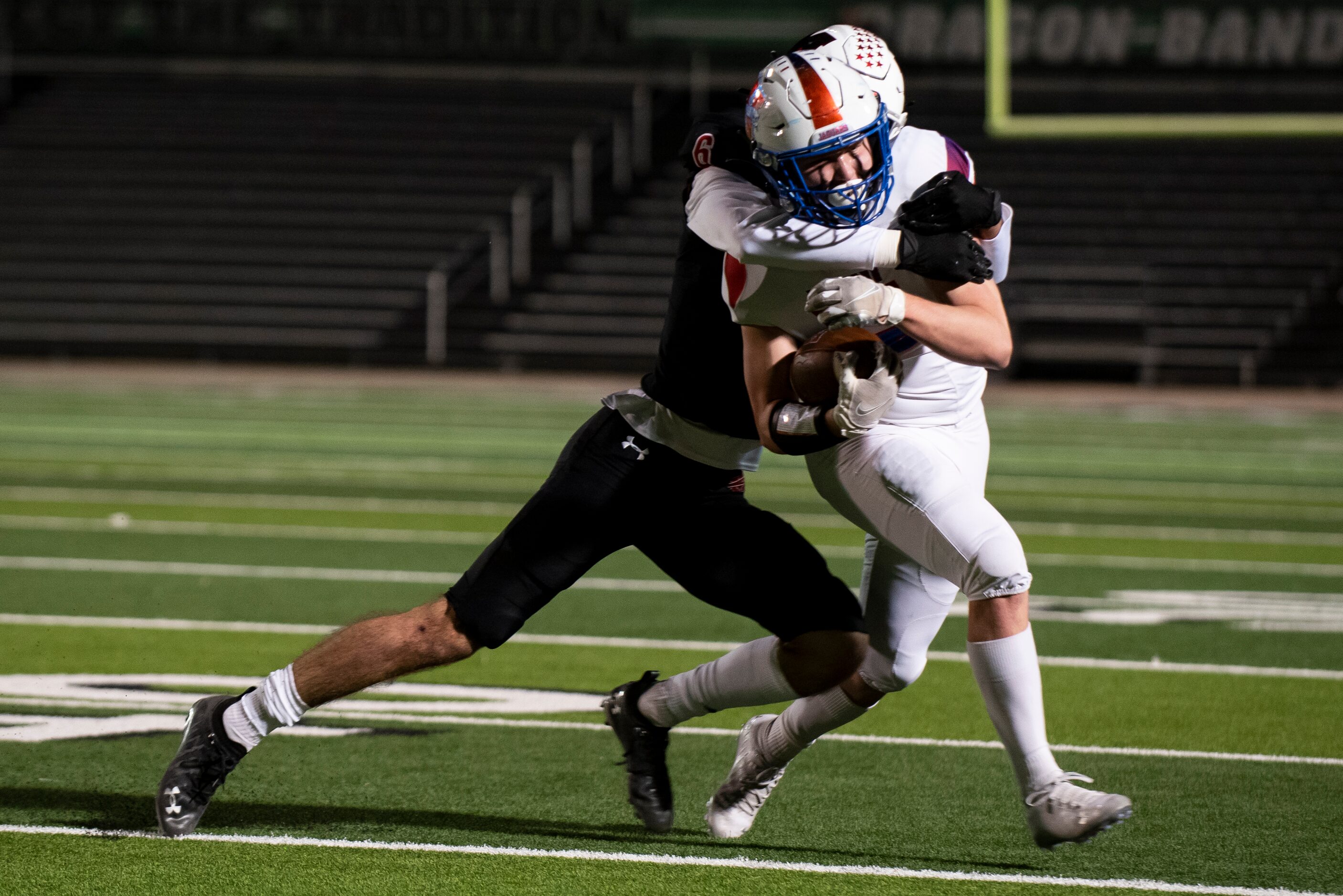 Midlothian Heritage junior Colton Kyle (12) is tackled by Melissa senior Ryan Johnson (6)...