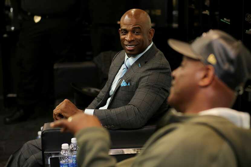 IMAGE DISTRIBUTED FOR NEW ERA CAP - Deion Sanders, left, sits down with Derrick Brooks for...