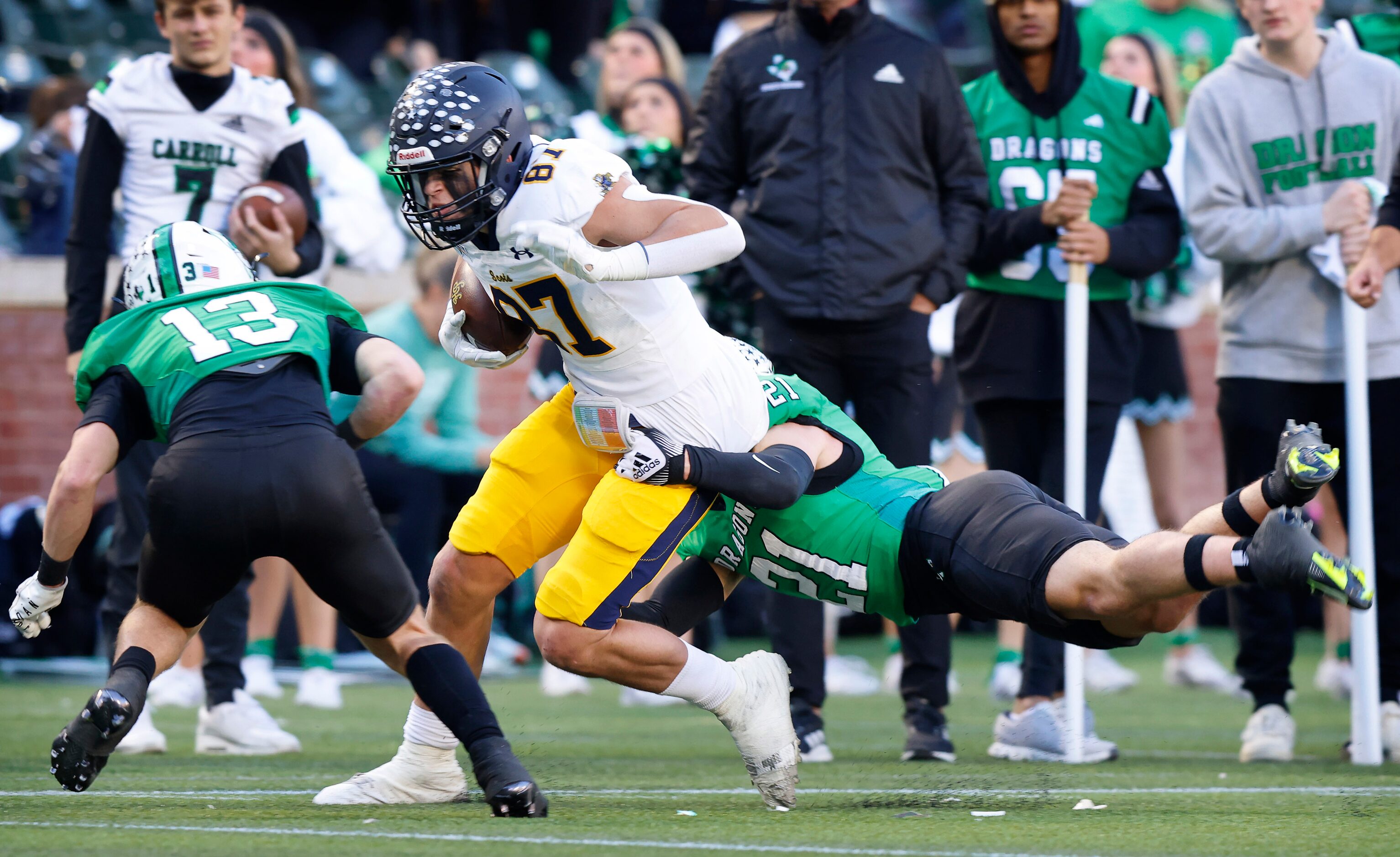 Southlake Carroll defensive back Zack Engelhardt (21) makes a diving tackle of Highland Park...