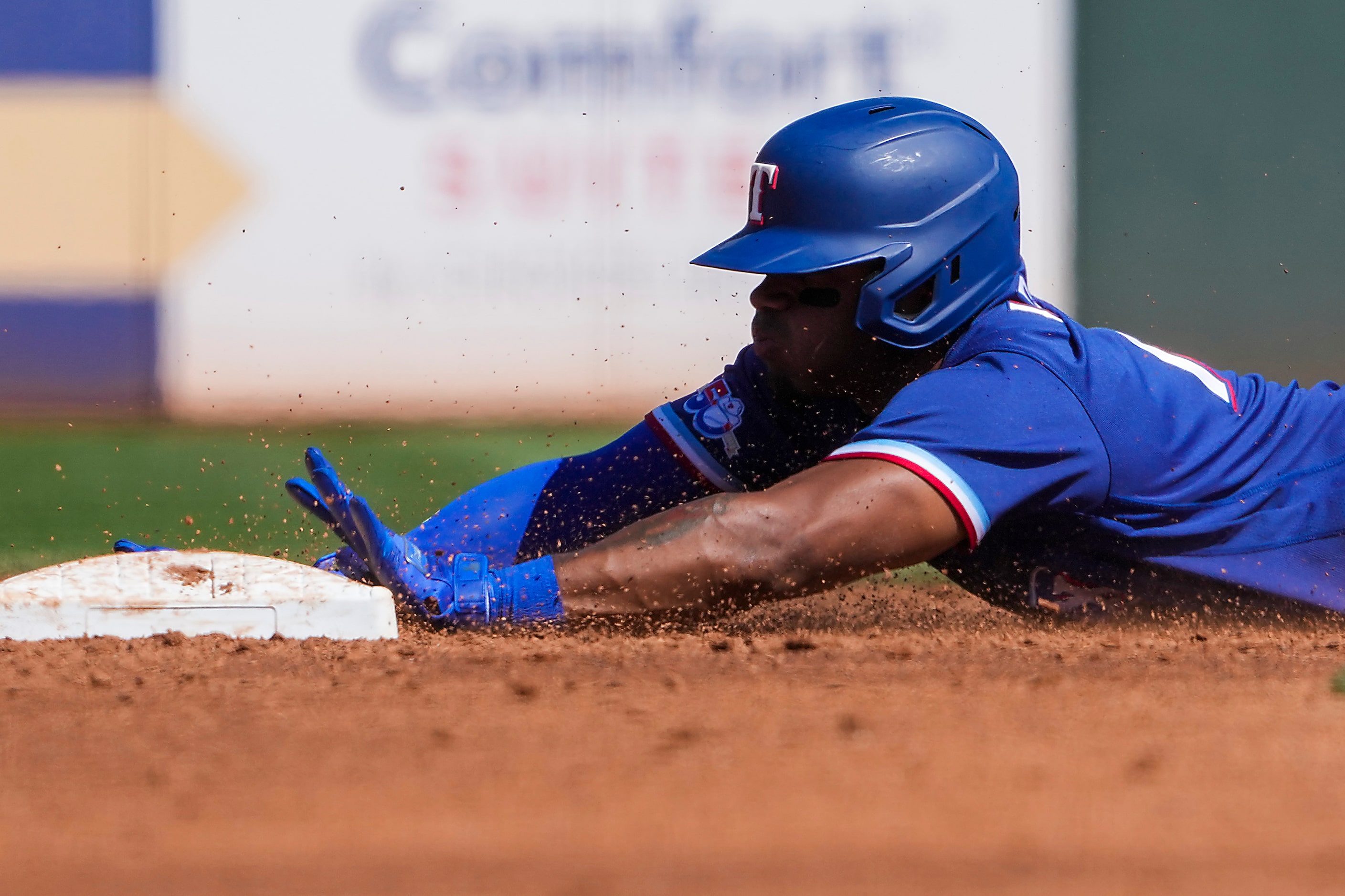 Texas Rangers infielder Andy Ibáñez is safe at second base with a double during the third...