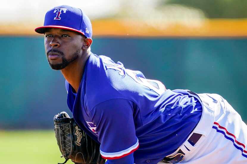 Texas Rangers pitcher James Jones participates in a fielding drill during a spring training...