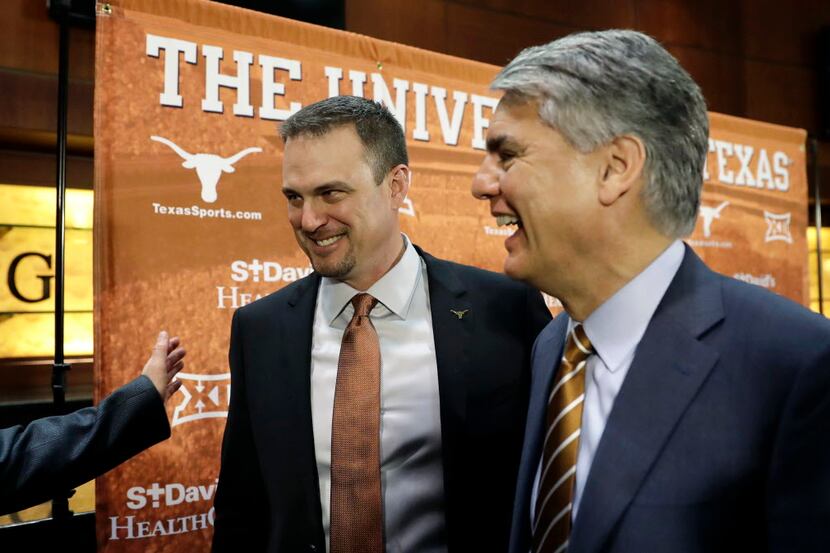 New Texas head NCAA college football coach Tom Herman, left, and president Gregory Fenves,...