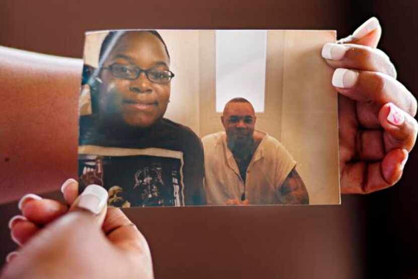 
Talia Clay, who holds a photo of her son, Jordan King (left), and his father and her fiance...