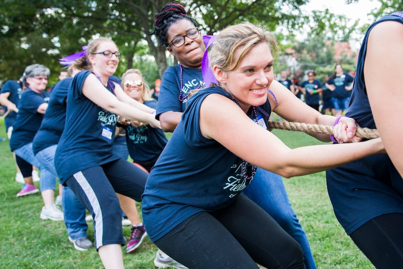 Encompass Home Health employees participate in a tug-o-war during a team building field day...