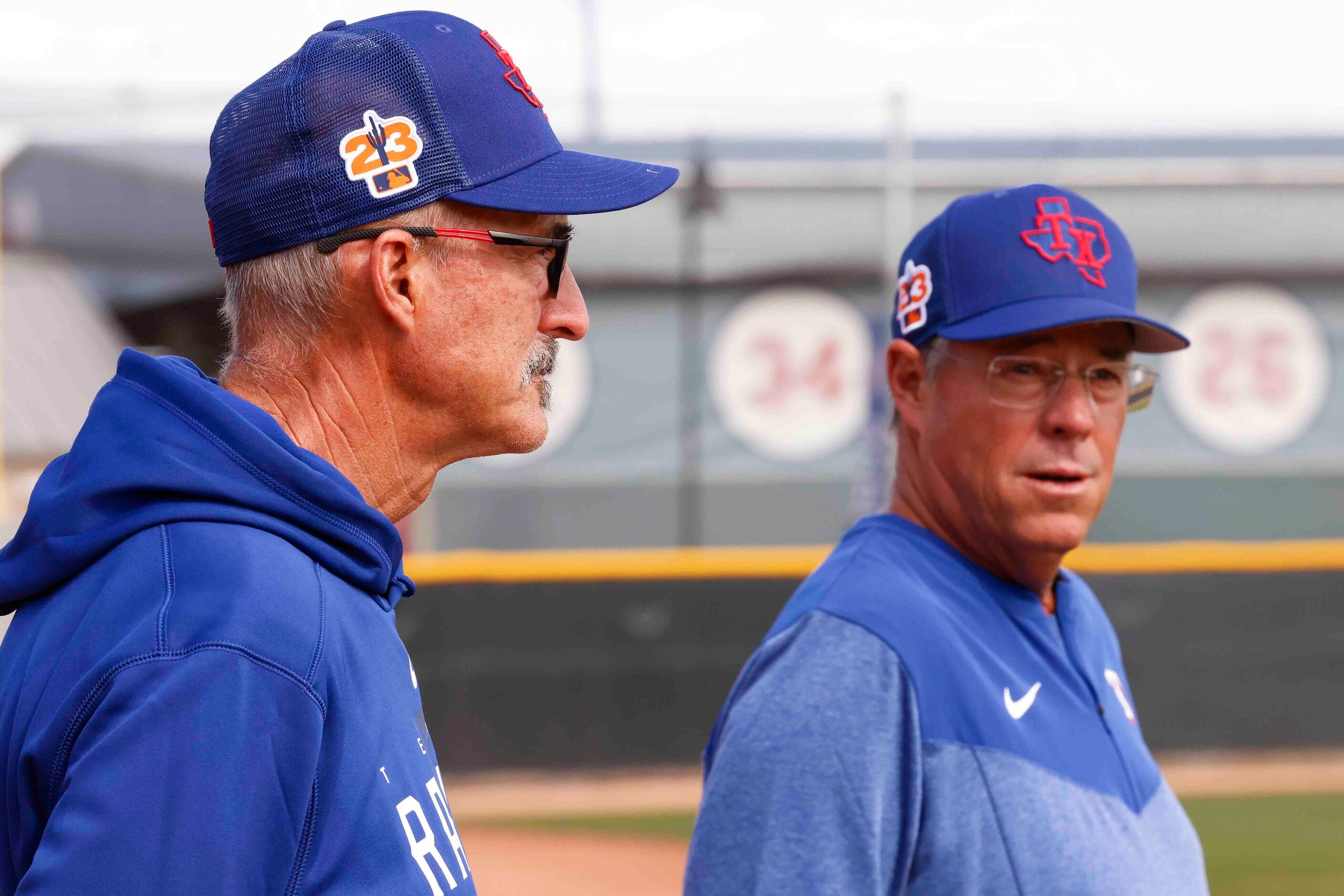 Texas Rangers pitching coach Mike Maddux, left, and special assistant Greg Maddux watch a...