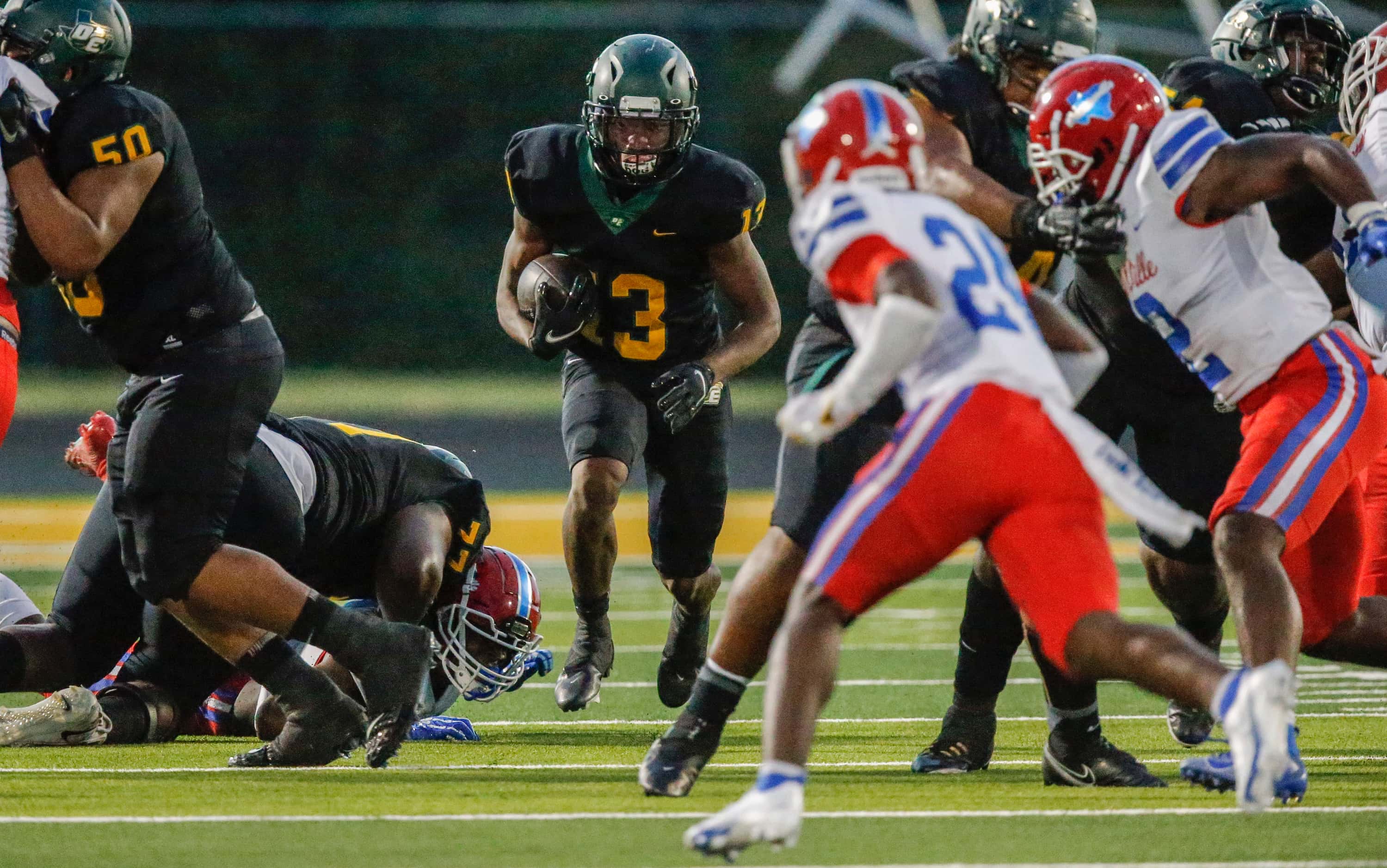 DeSoto junior running back Cameron Wright (13) looks for room against the Duncanville...