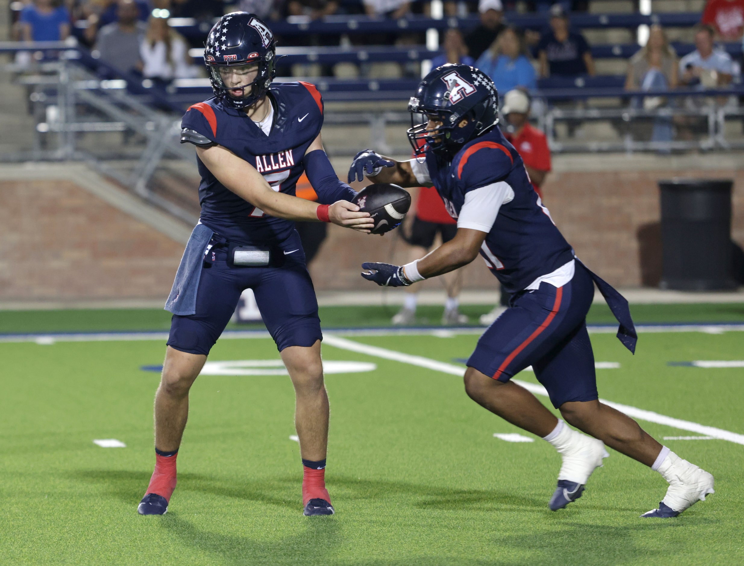 Allen player #7 Brady Bricker hands off the ball to #21 Jaden Hambric during the Prosper...