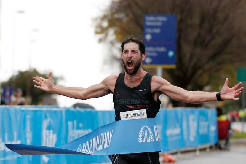 Logan Sherman reacts to winning the 45th running of the Dallas Marathon in downtown Dallas...
