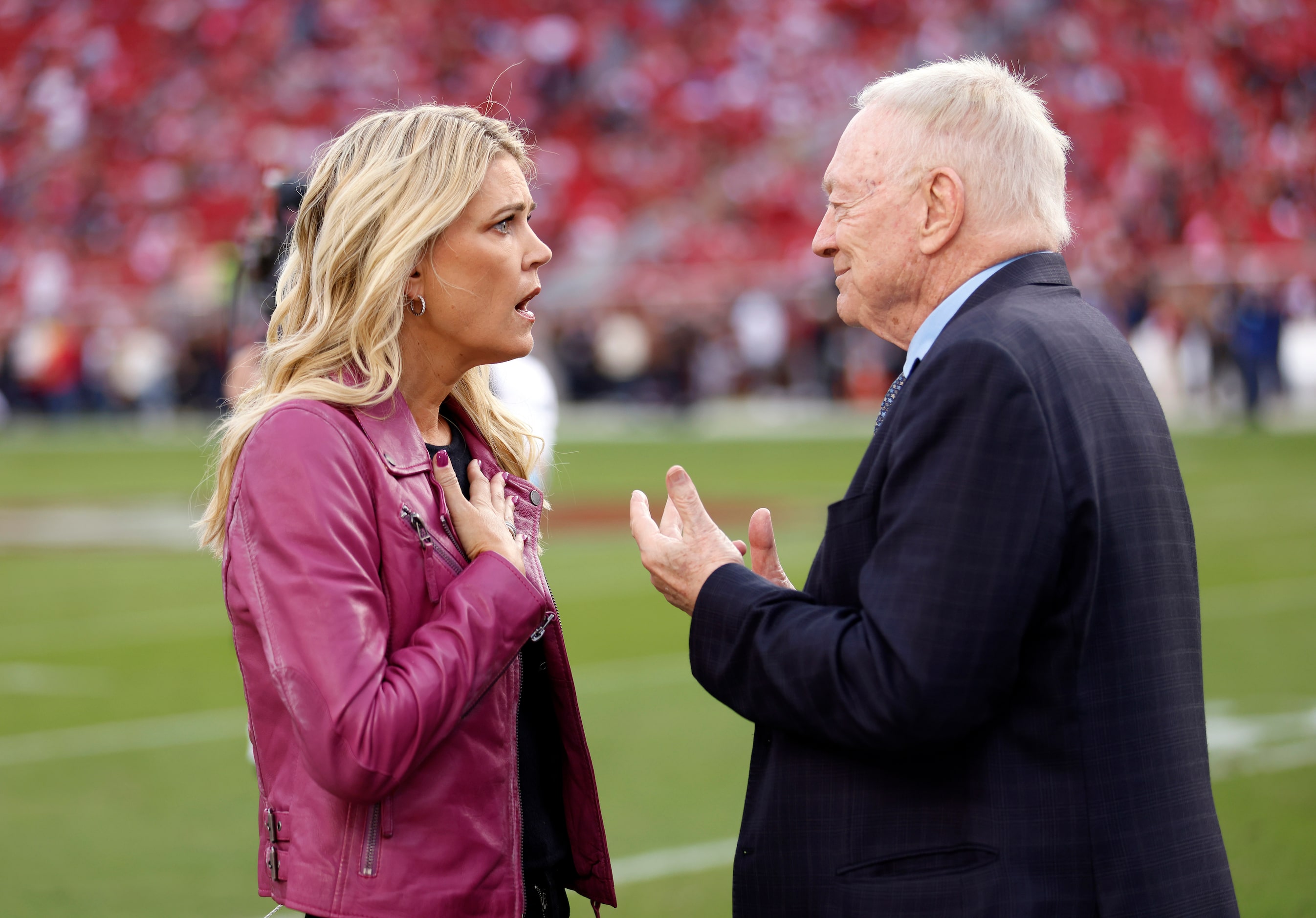 NBC Sports sideline reporter Melissa Stark reacts as Dallas Cowboys owner Jerry Jones tells...