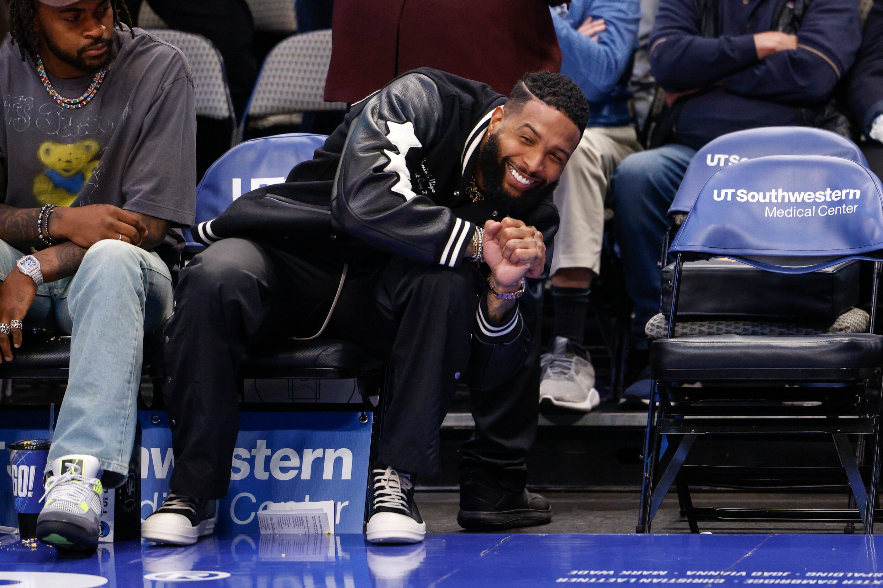 NFL free agent Odell Beckham Jr. talks to people during the first half of an NBA game...