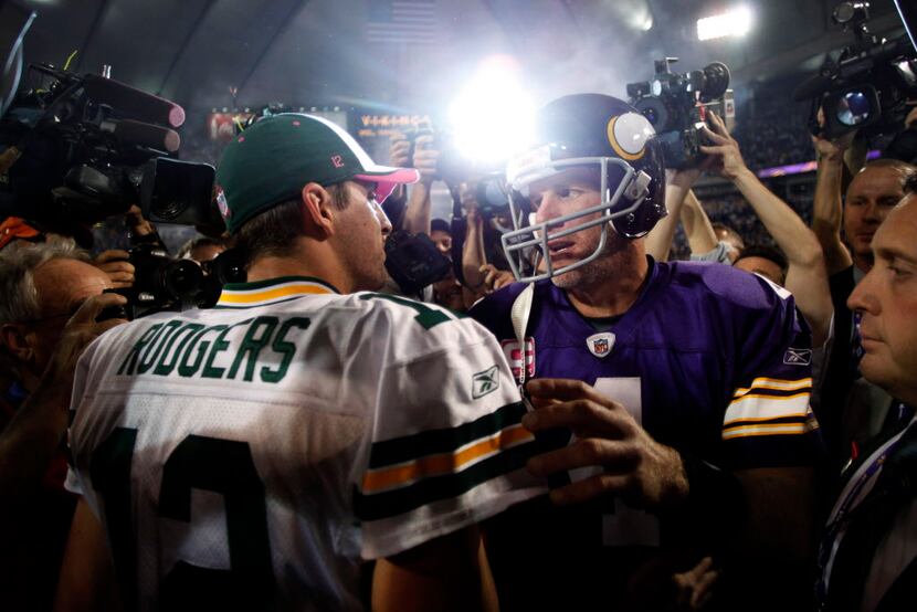 FILE - Minnesota Vikings quarterback Brett Favre (4) and Green Bay Packers quarterback Aaron...