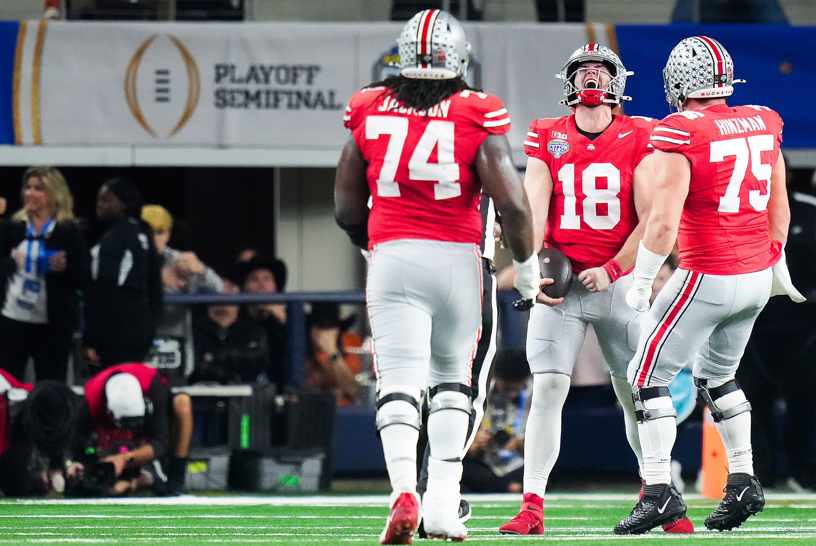 Ohio State quarterback Will Howard (18) celebrates after picking up 18 yards on a...