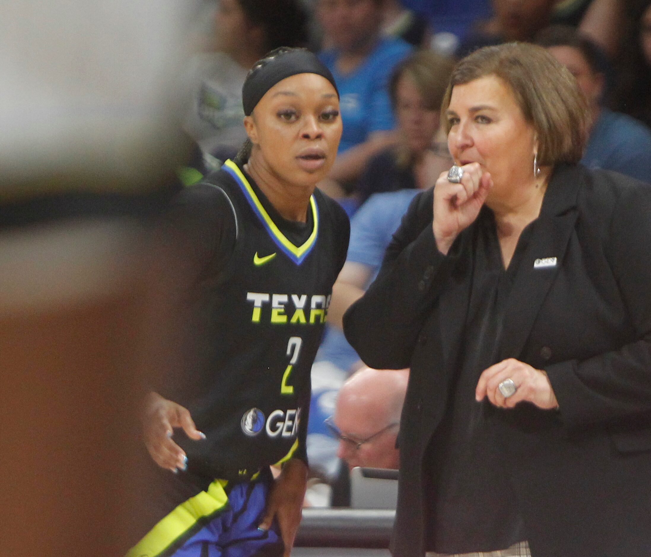 Dallas Wings head coach Latricia Trammell sneaks in a quick bit of game strategy to Wings...