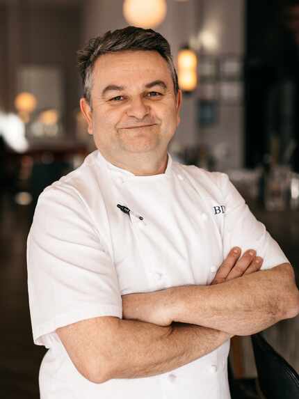 Chef smiles in his restaurant