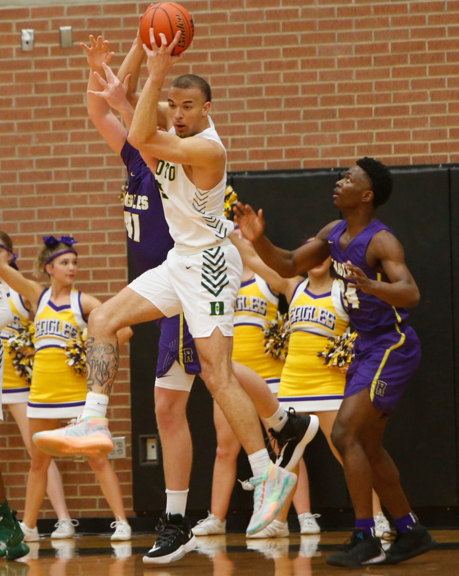 DeSoto's Duncan Powell (31) skies to pull down a defensive rebound over Richardson forward...