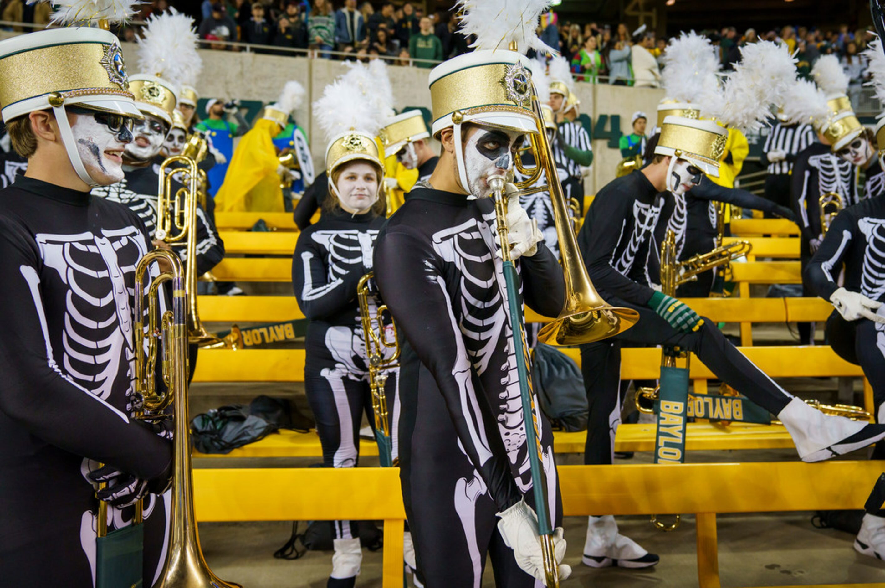 Members of the Baylor band wear Halloween costumes as they warm up before their team takes...