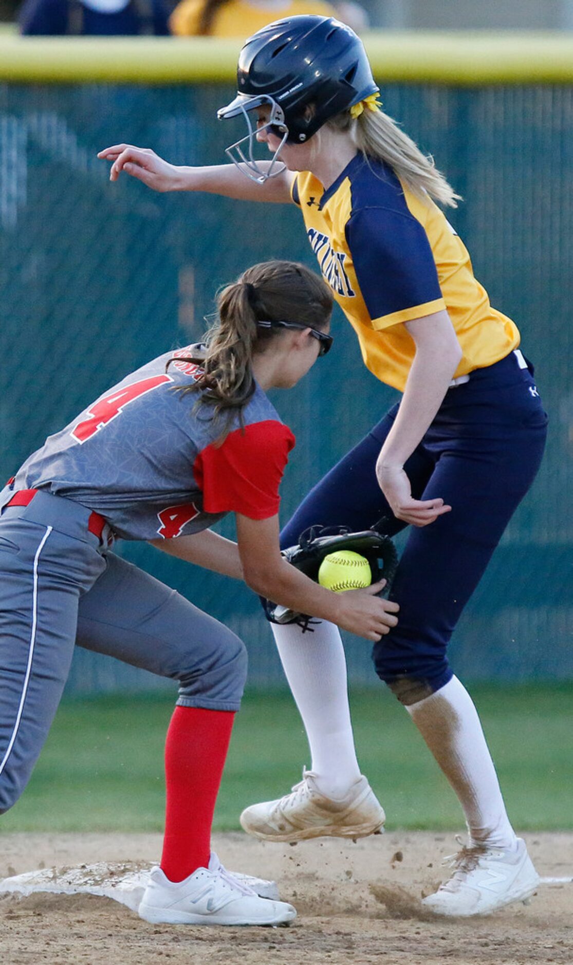 McKinney High School pitcher Jo Cabana (2) was called safe at third base as McKinney Boyd...