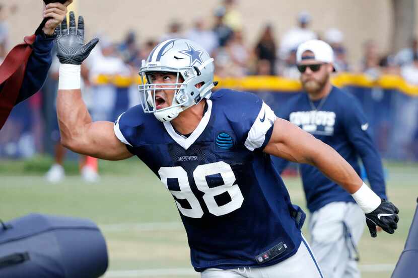 Dallas Cowboys defensive end Tyrone Crawford (98) reaches for the ball in a drill during the...