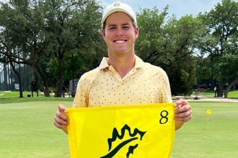 Parker Coody holds up the hole's flag after shooting a hole and one.