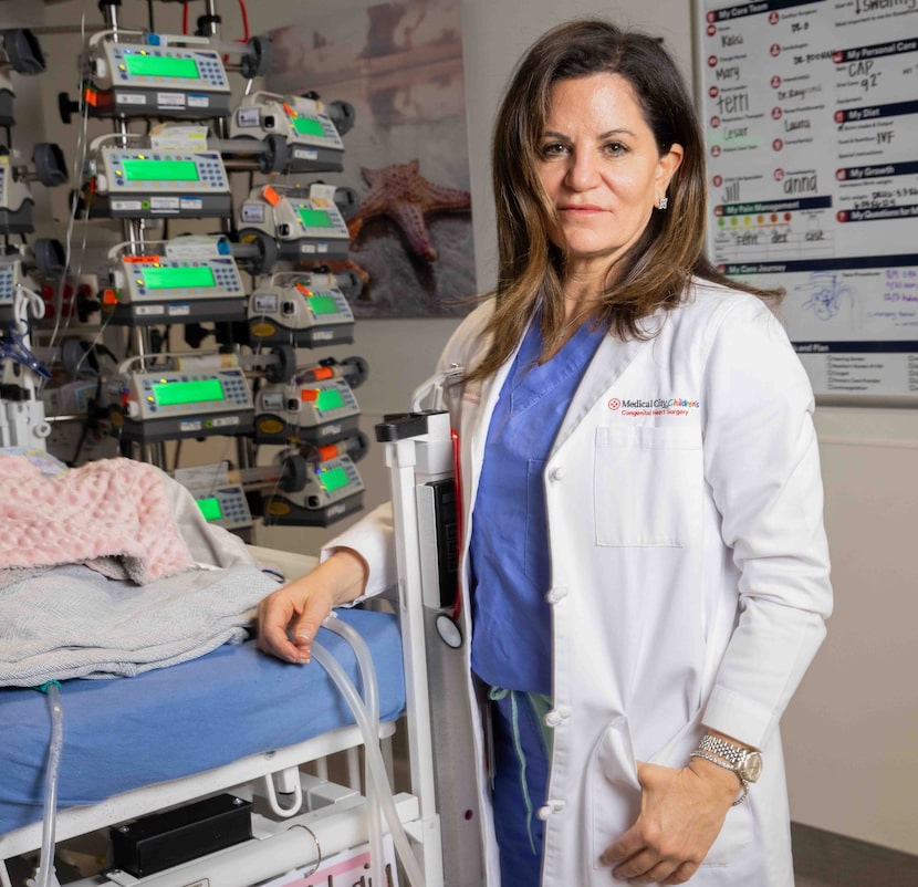 Dr. Kristine J. Guleserian poses for a photo at the bed of her four-month-old patient...