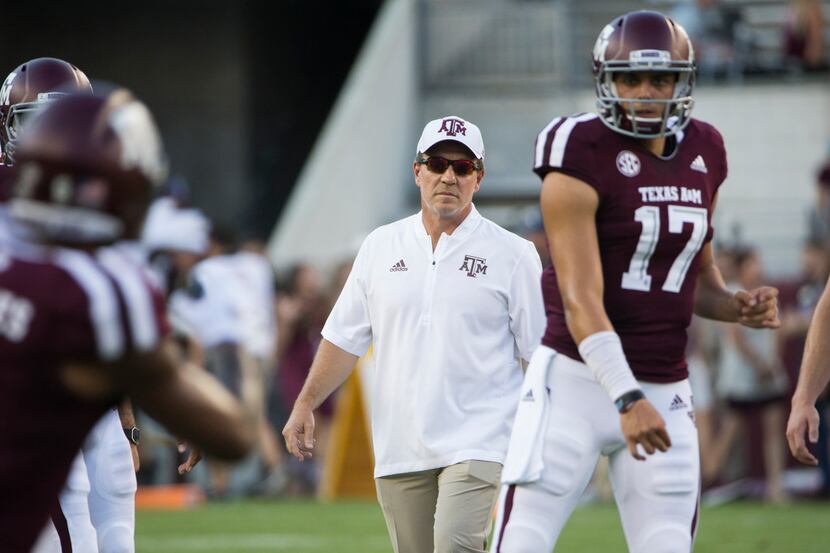 Texas A&M Aggies head coach Jimbo Fisher works with players during warmups for a matchup...