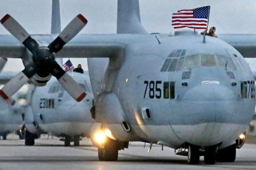 C-130 transports taxi in after landing, as US Marine Corps troops return from overseas...