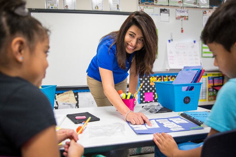 Bilingual teacher Olivia Mendez works with her second-graders at Shands Elementary. 