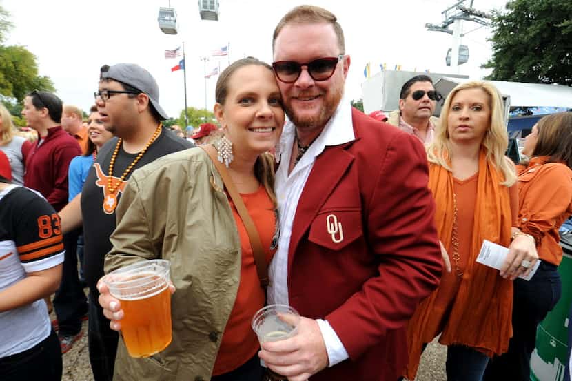 Laura Cunningham and Oklahoma University alumni Chris Fields hold beers outside the Cotton...