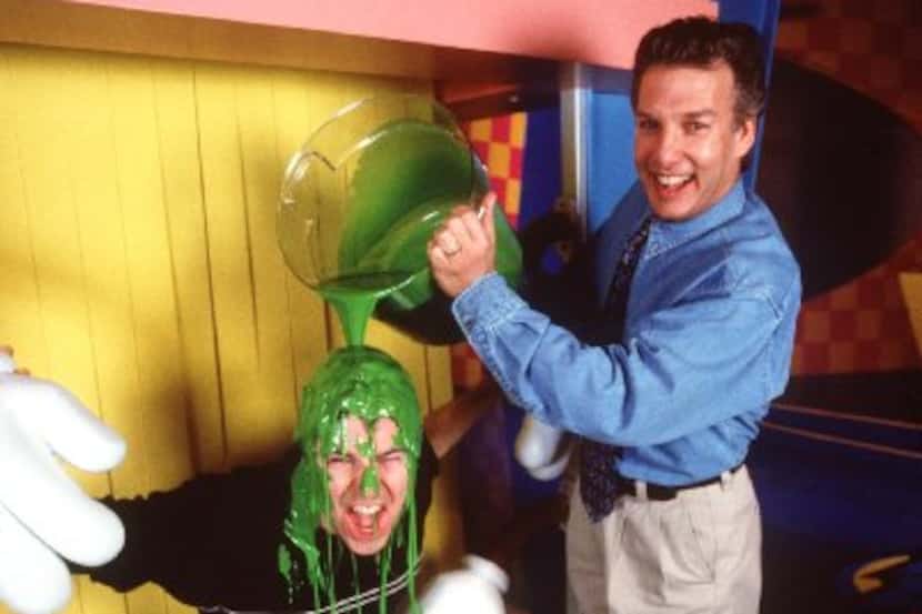 In this DMN file photo, Double Dare 2000 host Jason Harris gets slimed by Marc Summers, host...