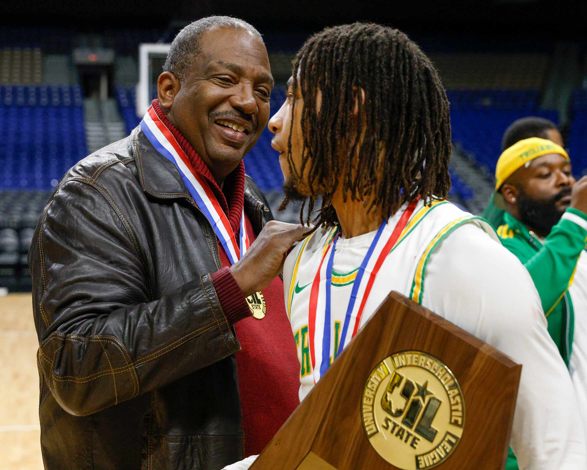 State Sen. Royce West speaks with Madison guard Pierre Hunter (1) after the Class 3A state...