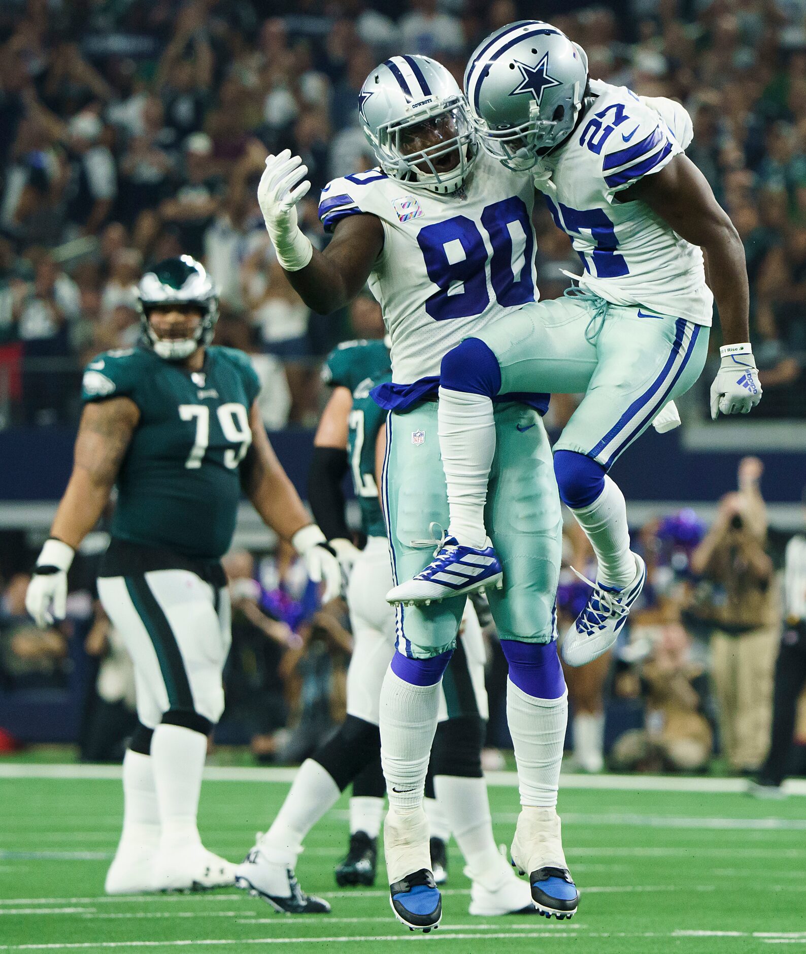 Dallas Cowboys cornerback Jourdan Lewis (27) celebrates with defensive end Demarcus Lawrence...