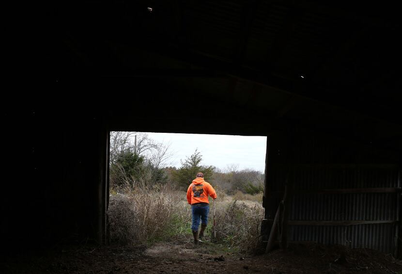 Dennis Abercrombie walks through a shed in northern Collin County during a recent search. 