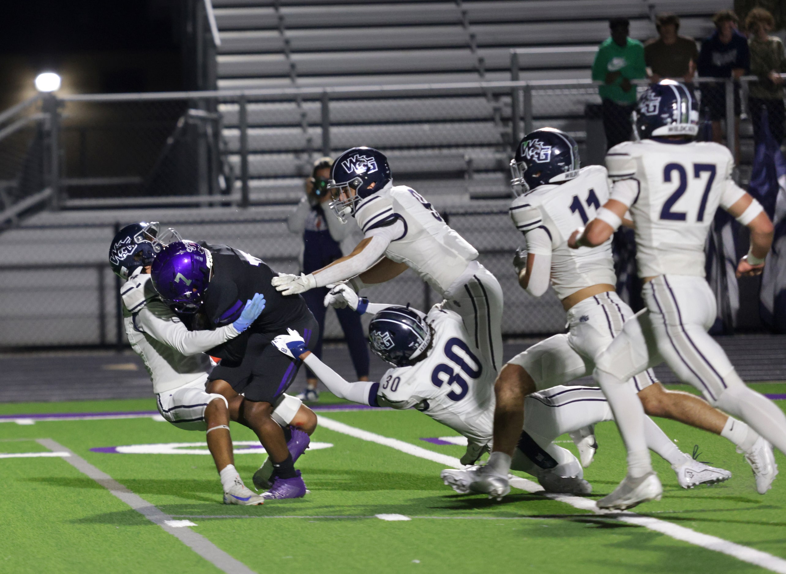 Anna player #7 Ace Traylor is taken down after a catch during the Prosper Walnut Grove High...