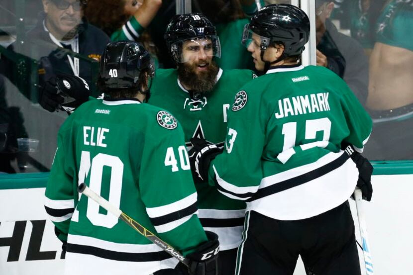 Dallas Stars right wing Patrick Eaves, center, celebrates his goal with teammates Remi Elie...
