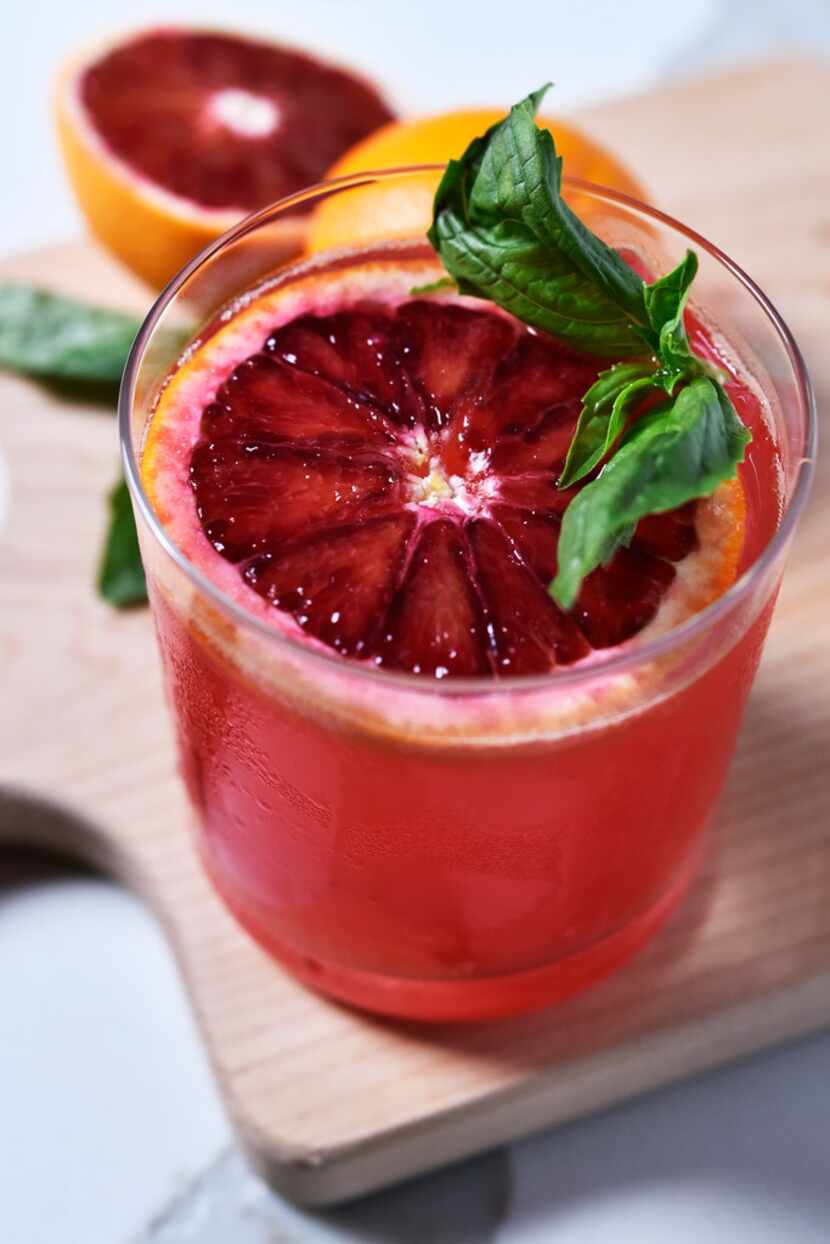 A blood orange basil spritzer mocktail made with blood orange juice, basil simple syrup and...