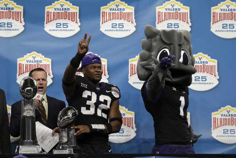 SAN ANTONIO, TX - DECEMBER 28:  Travin Howard #32 of the TCU Horned Frogs receives the...