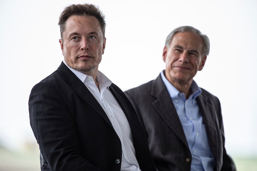 Tesla CEO, Elon Musk (left) sits with Texas Gov. Greg Abbott at a groundbreaking ceremony...