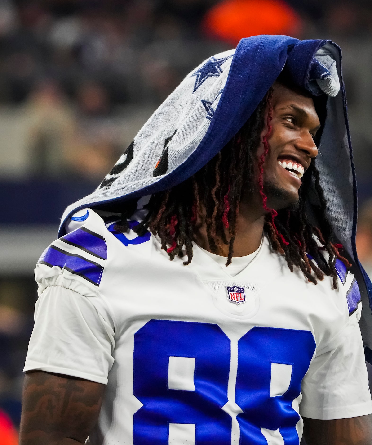 Dallas Cowboys wide receiver CeeDee Lamb laughs on the bench during the fourth quarter of...