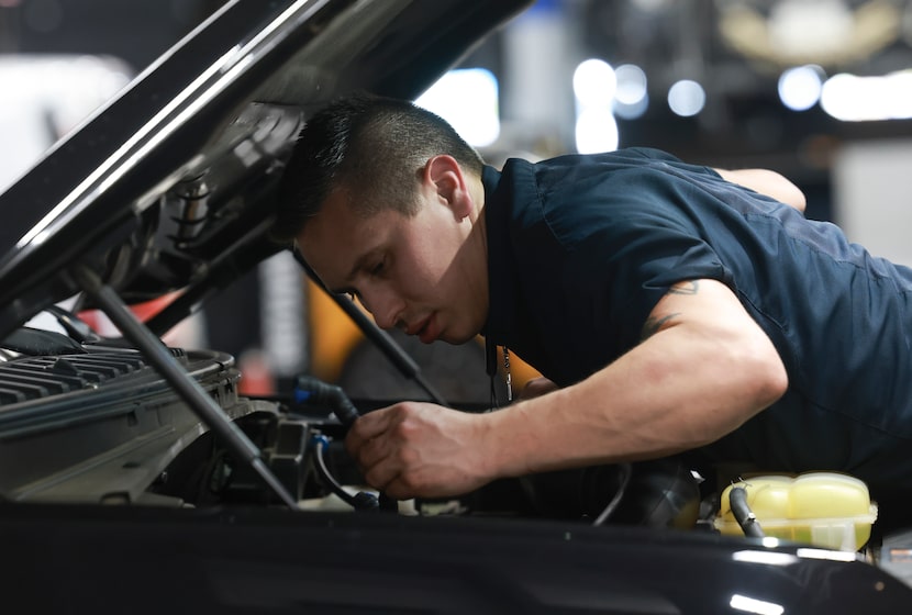 Kevin Kofsky looks under the hood of a Ford Expedition at Five Star Ford of Dallas.