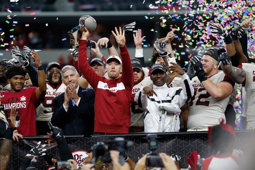 Oklahoma Sooners head coach Lincoln Riley (center) celebrates after winning the NCAA Big 12...