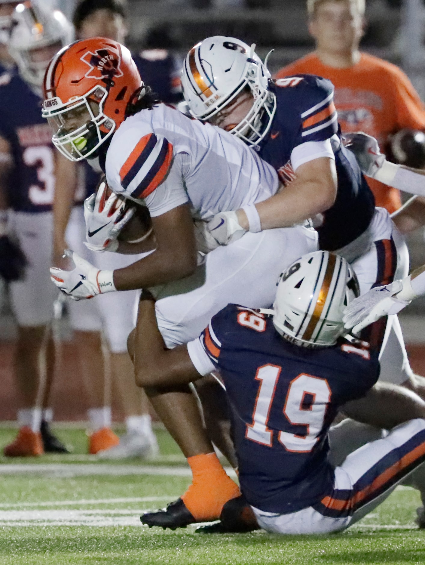 McKinney North High School wide receiver Kameron Powell (1) is tackled by Wakeland High...