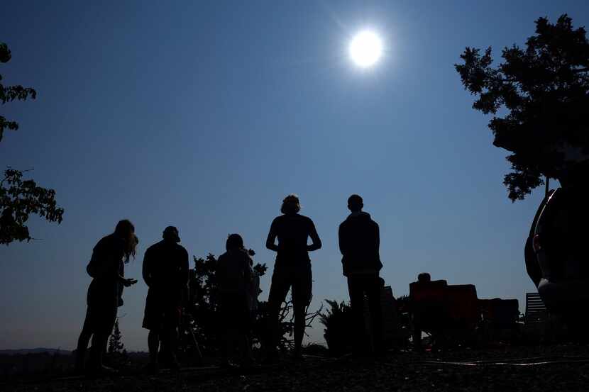 FILE - People gathered near Redmond, Ore., to view the sun as it neared a total eclipse by...