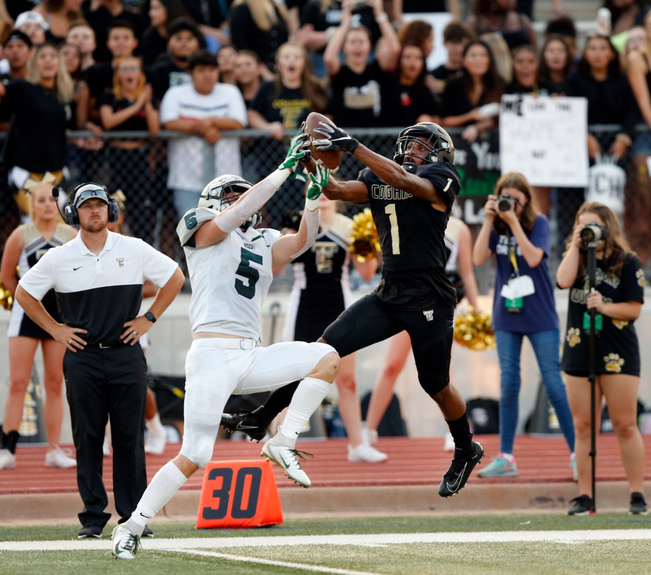 The Colony wide receiver Myles Price (1) goes high to snare the ball from Frisco Reedy...